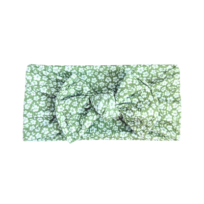 Floral headband with green and white pattern on a white background