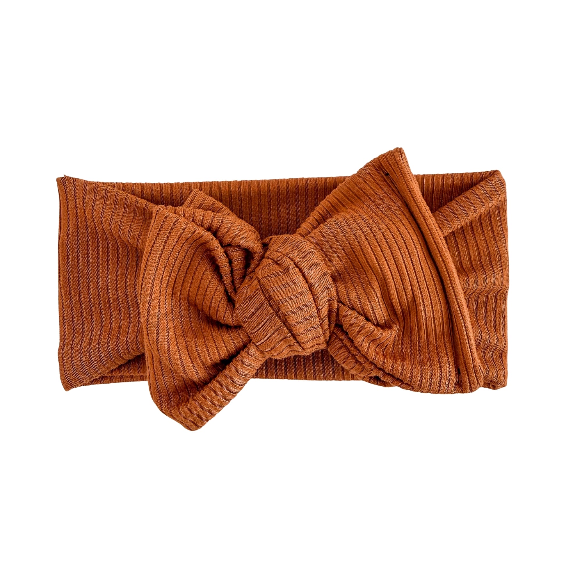 Oversized bow baby headband in dark orange, crafted from ribbed knit fabric, displayed on a white background
