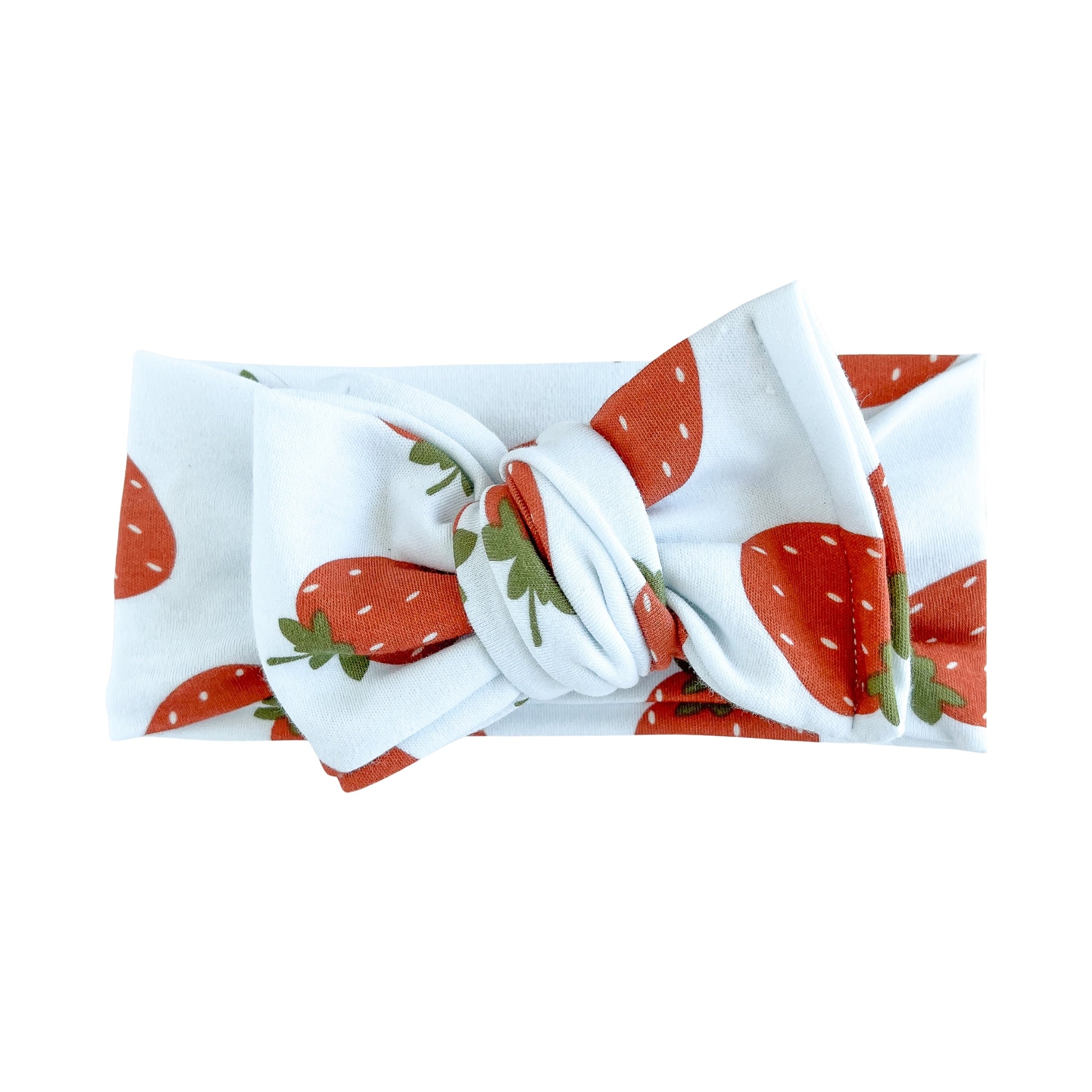 Oversized bow baby headband in white with red strawberry print, crafted from cotton jersey knit fabric, displayed on a white background