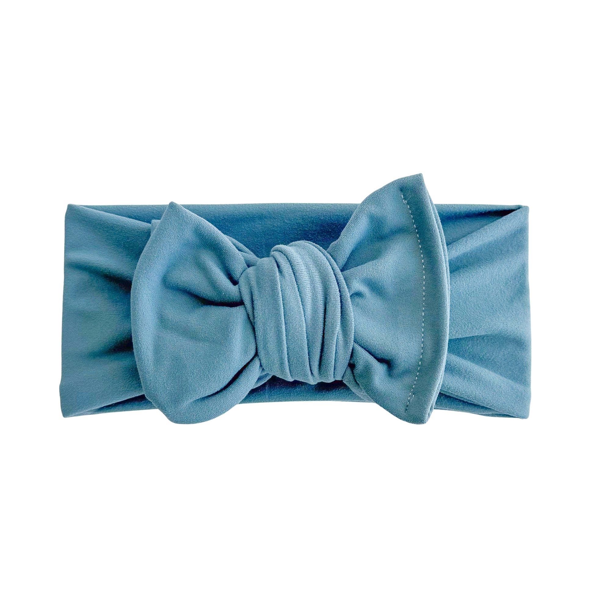 Oversized bow baby headband in teal, crafted from double brushed knit fabric, displayed on a white background
