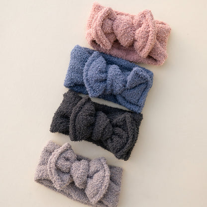 Set of five teddy headbands with bow designs on a light background