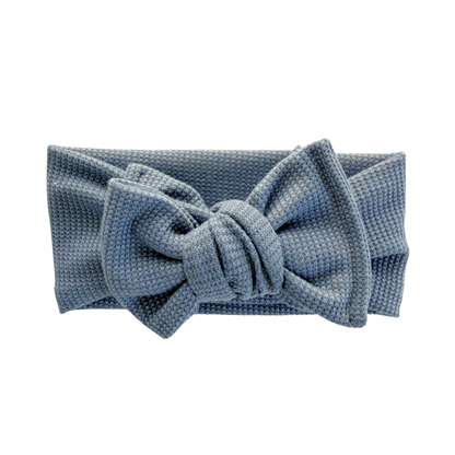 Dusty blue waffle oversized bow headband on a white background