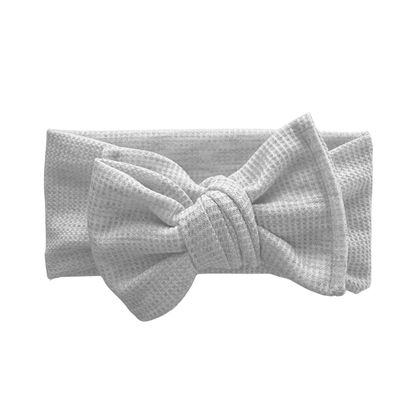 Light gray waffle oversized bow headband with a bow on a white background