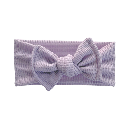Lavender waffle top knot baby bow headband a white background.