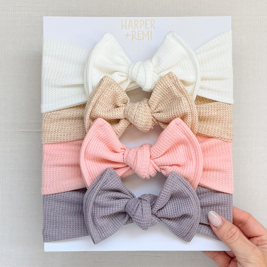 Set of four waffle knit top knot bows in white, oatmeal, peachy pink, and lavender.