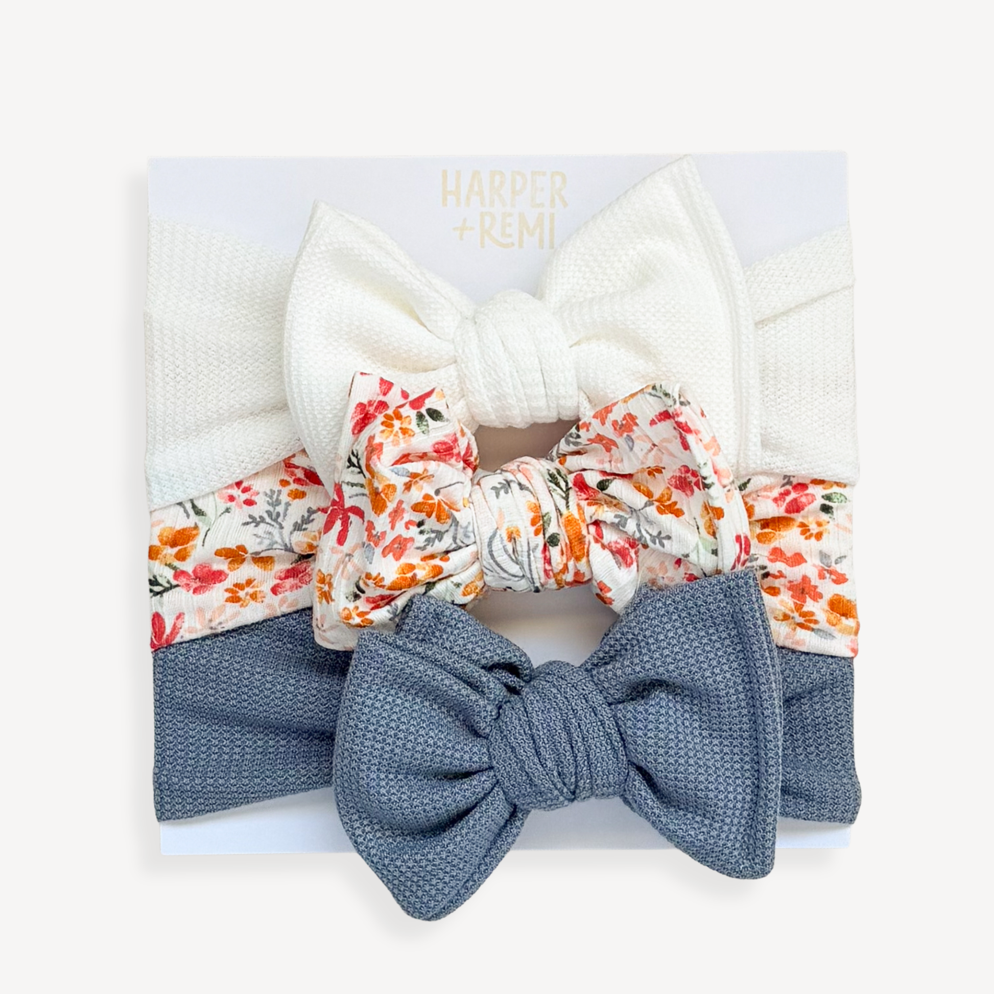Set of colorful hair bows and scrunchies in a box with a blurred background