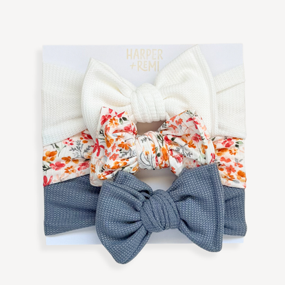 Set of colorful hair bows and scrunchies in a box with a blurred background
