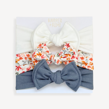 Set of colorful hair bows in a box held by a hand