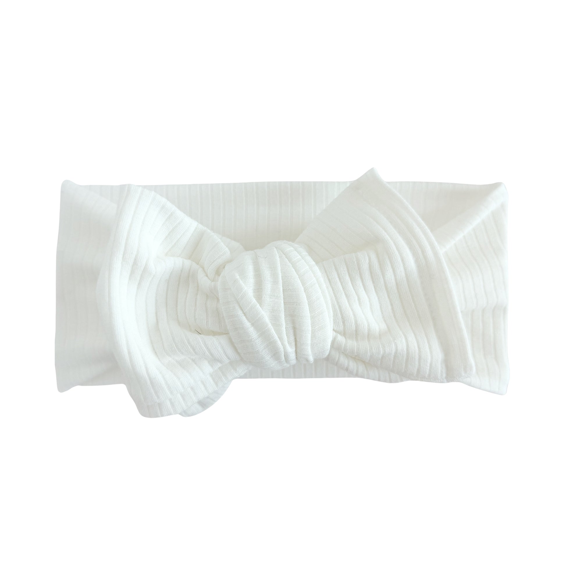 Oversized bow baby headband in white, crafted from ribbed cotton jersey knit fabric, displayed on a white background
