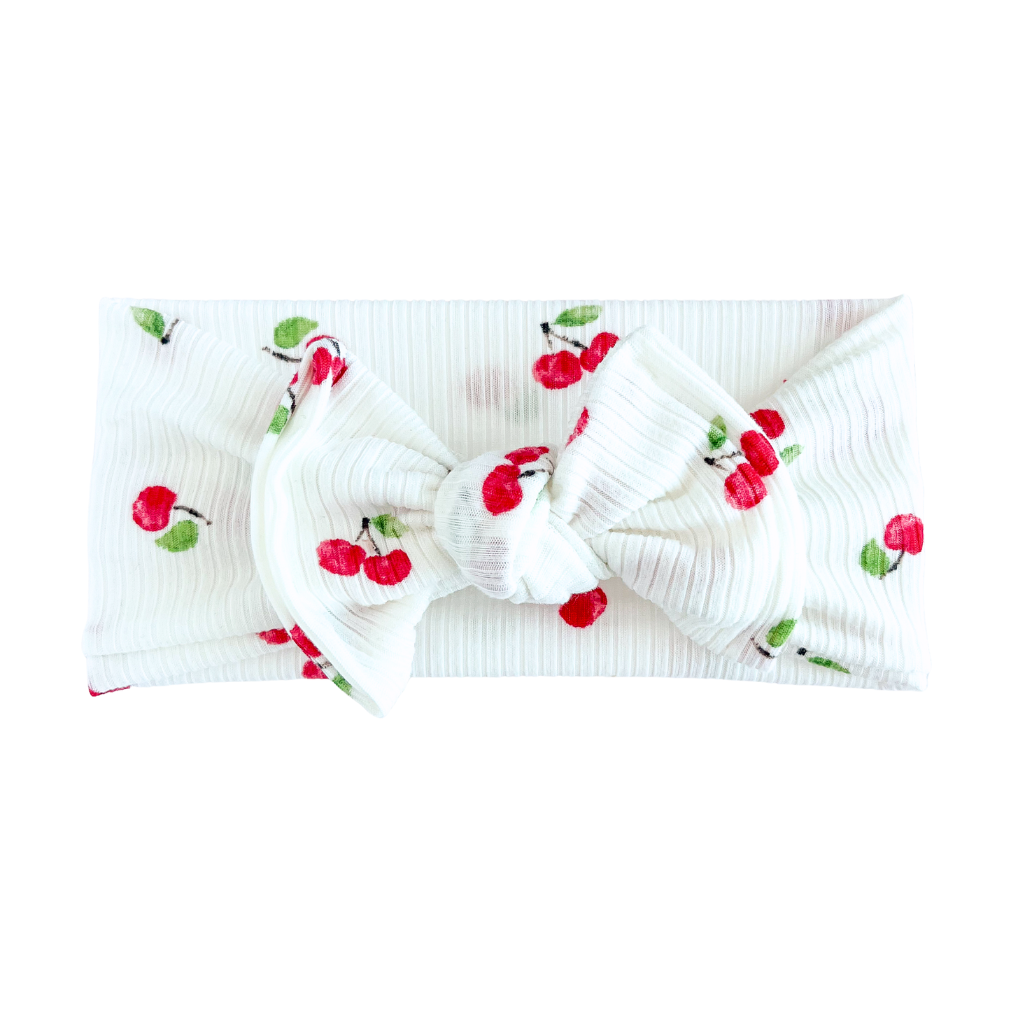 White top knot headband with cherry designs on a white background