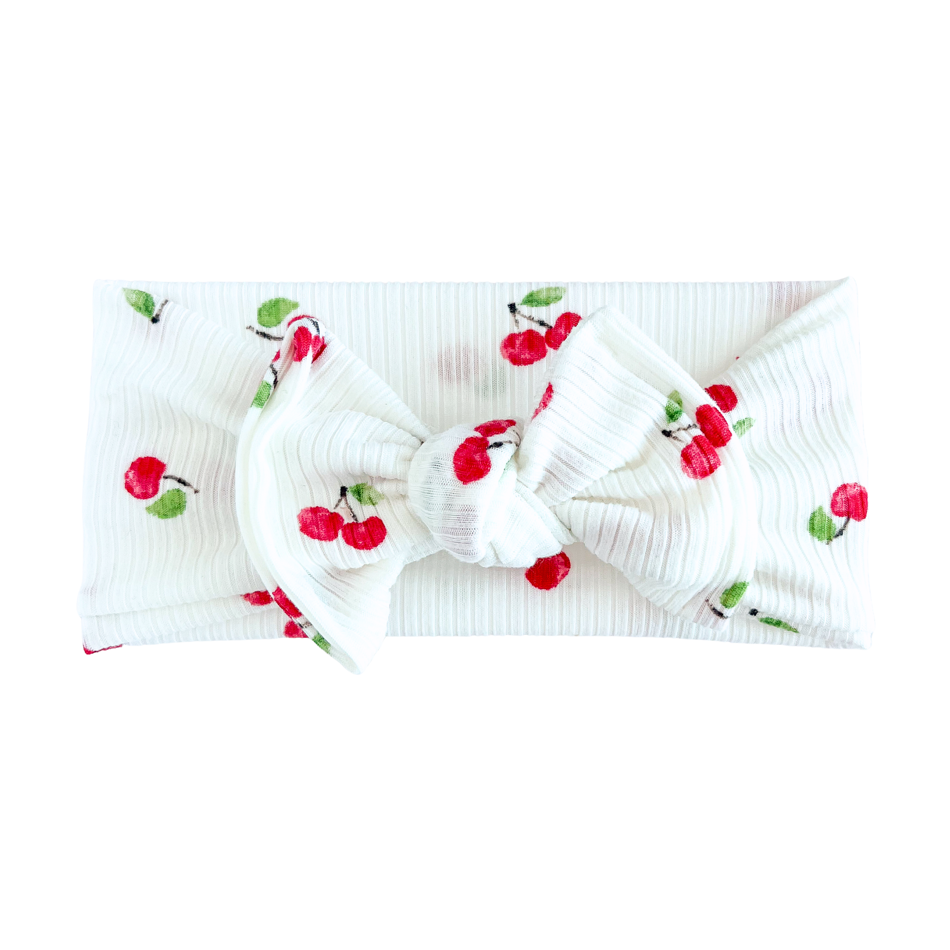 White top knot headband with cherry designs on a white background