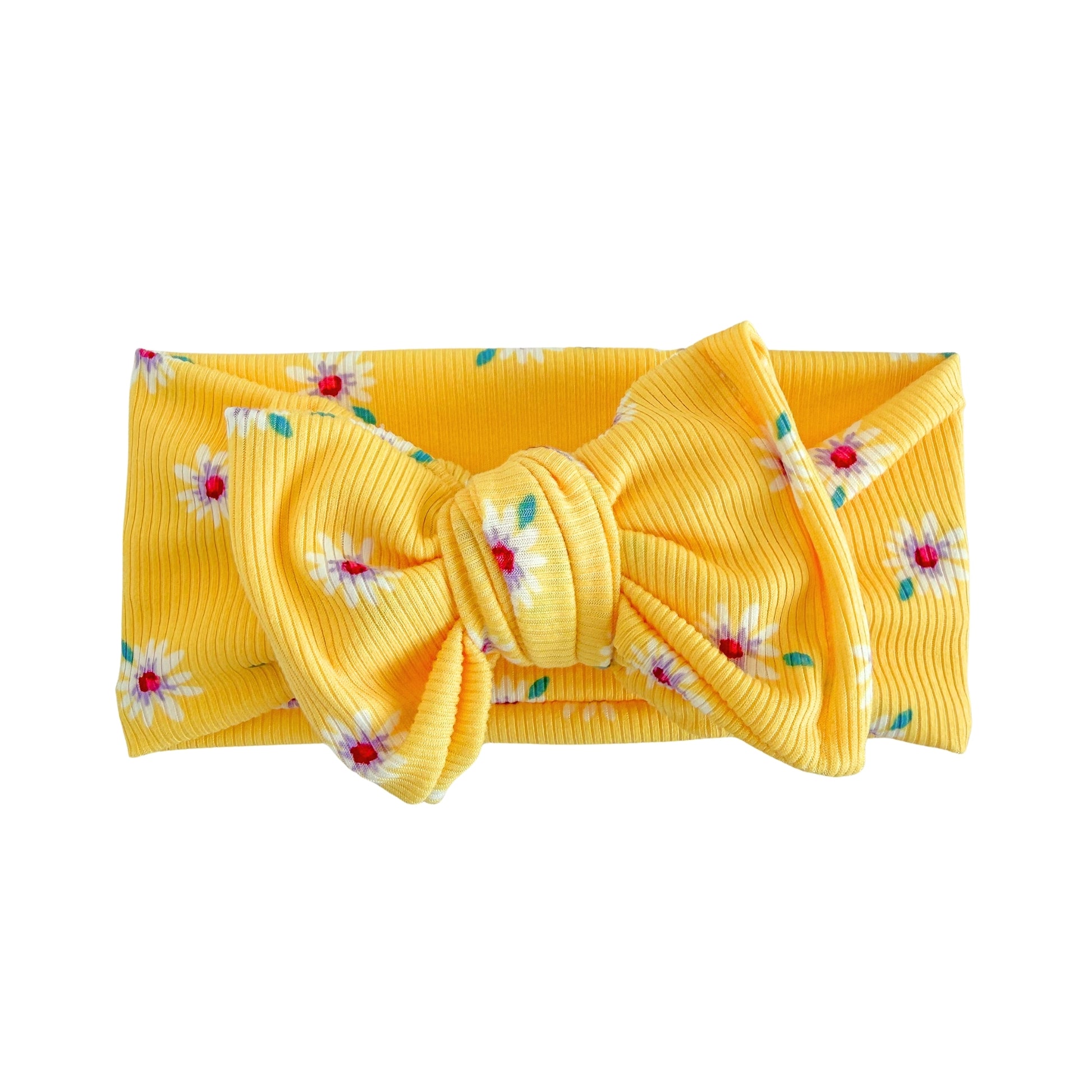 Top knot baby headband in bright yellow with white daisies print, crafted from ribbed knit fabric, displayed on a white background